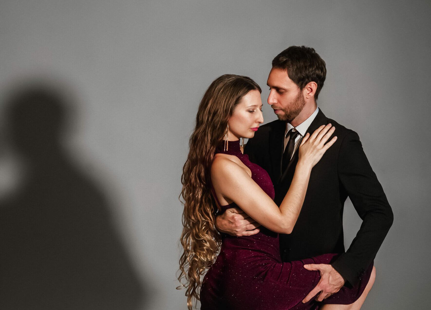 Couple performs a dramatic Argentine tango gancho leg hook move.